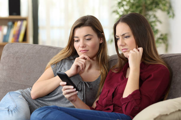 istock Upset friends watching on line content in a smart phone 658979810