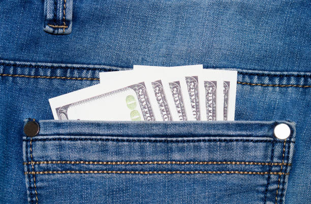 istock Jeans with dollars in pocket 658990952