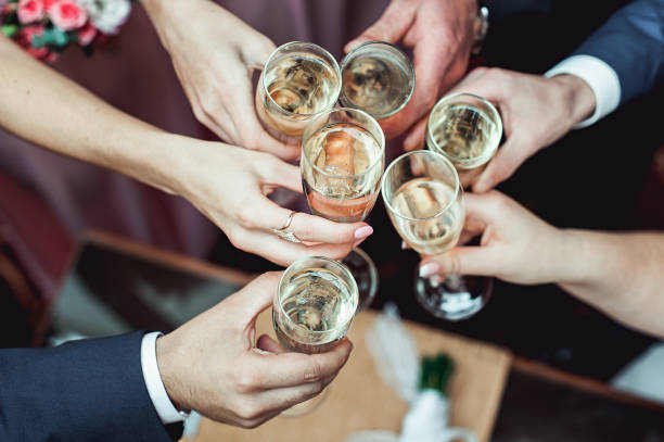 people hold in hands glasses with white wine. wedding party. - champagne champagne flute wedding glass imagens e fotografias de stock