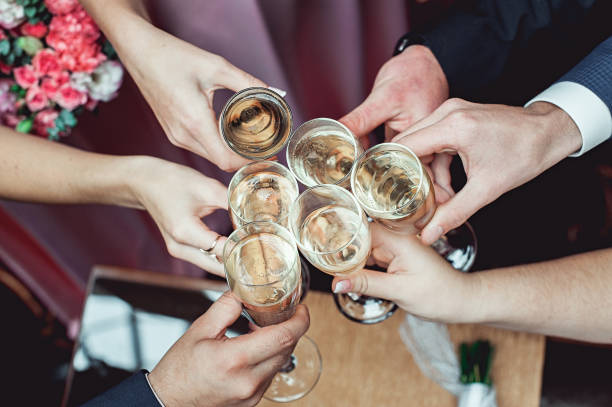 istock People hold in hands glasses with white wine. wedding party. 659000698