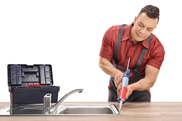 istock Plumber using a silicone tube on a sink 659001456