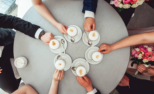 istock People holding in hands cups with coffe. 659008262