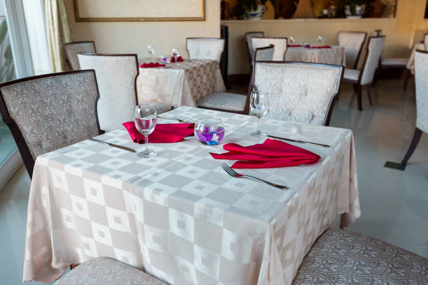 istock Empty glasses and dishes set in an interior new luxury restaurant with covered tables 659028714