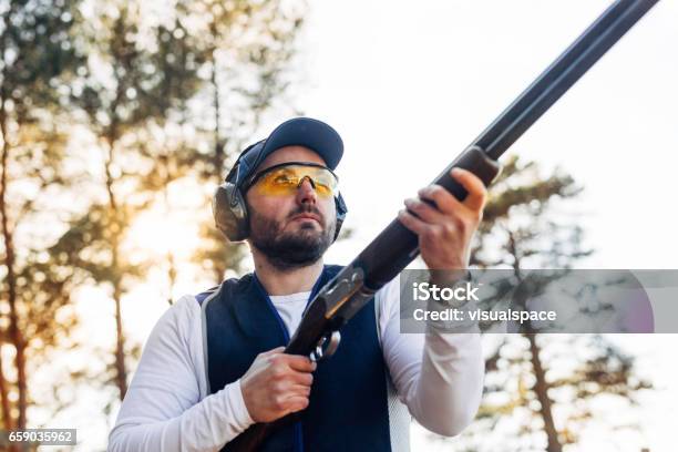 Clay Target Shooter In Sunset Stock Photo - Download Image Now - Shotgun, Trap Shooting, 30-39 Years