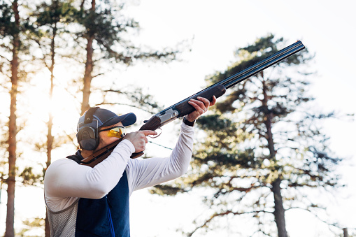 Professional trap shooter shooting clay targets.