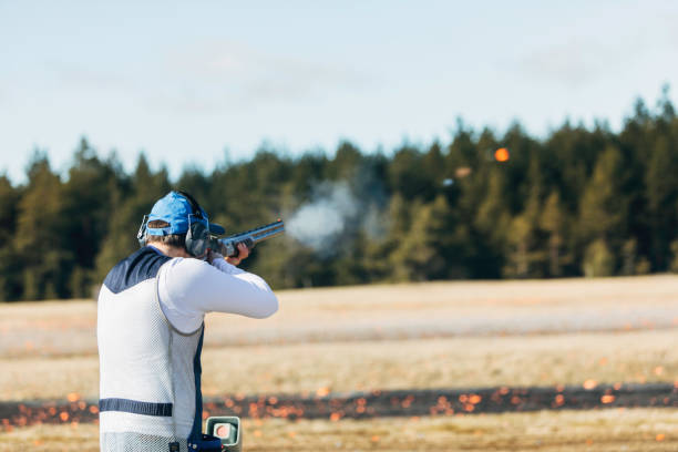 Clay target shooter Professional trap shooter shooting clay targets. target shooting stock pictures, royalty-free photos & images