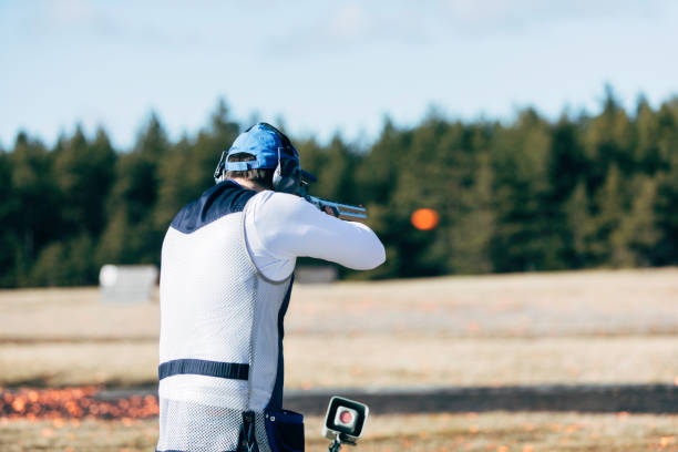 Clay target shooter Professional trap shooter shooting clay targets. trap shooting stock pictures, royalty-free photos & images