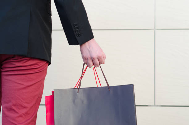 istock male hand holding a shopping bag 659047968