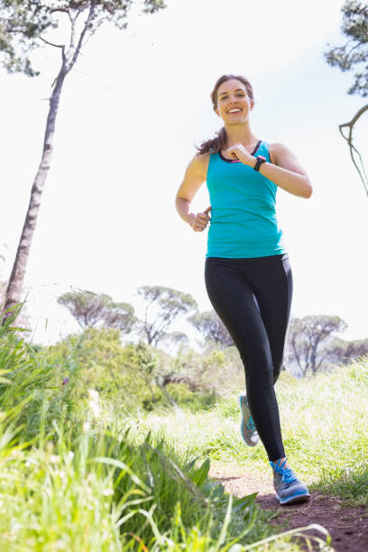 istock Smiling woman jogging 659062556