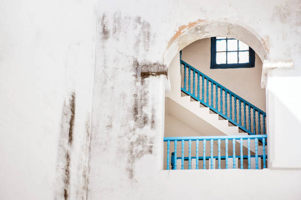 Havana, Cuba - January 20, 2017: View into a white house with a blue stairway.