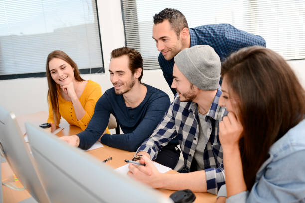 istock group of five young people student with teacher in computer school classroom learning programming with desktop computer in a row 659069220