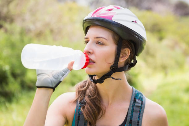 istock Woman drinking water and wearing helmet 659071356