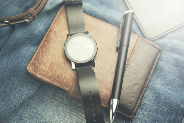 istock watch, wallet,phone and pen  on jeans 659075510