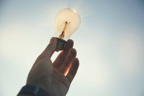 istock Menhand in light bulb the background of nature 659082400