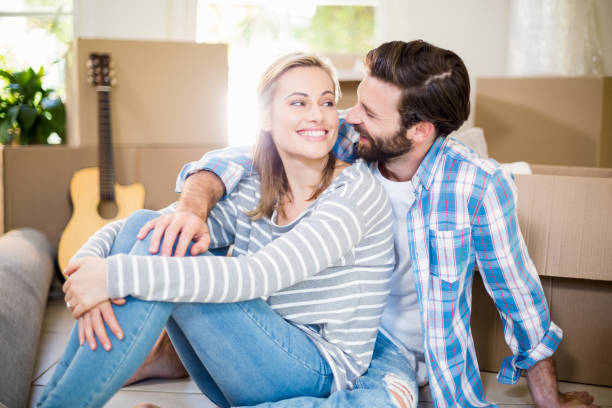 istock Smiling couple sitting on the floor 659110052
