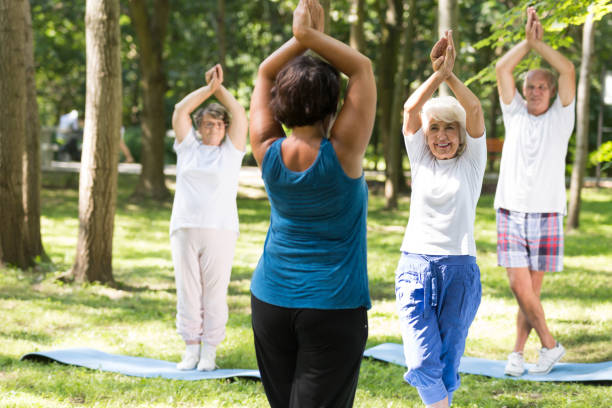 istock Smiling seniors having a yoga class outdoors 659112478
