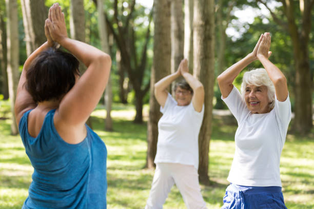 istock Women doing yoga in a park 659112520