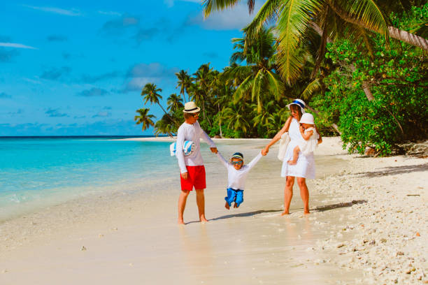 istock family with kids playing walking on tropical beach 659121384