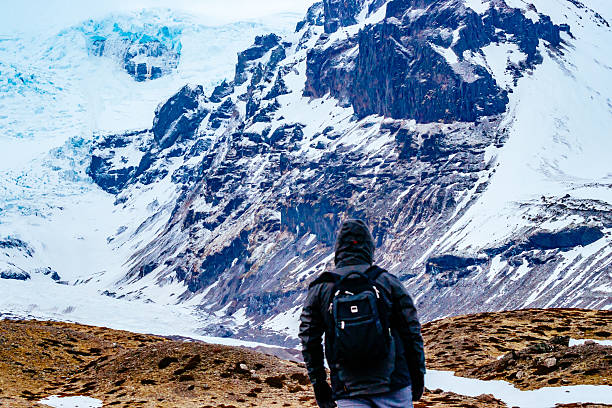 istock Rear View Of Man Walking On Snow Covered Landscape 659130691