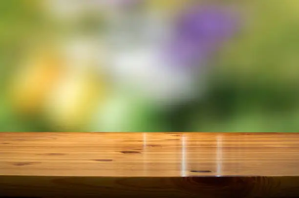 blurred springbackground with wooden desk in the foreground