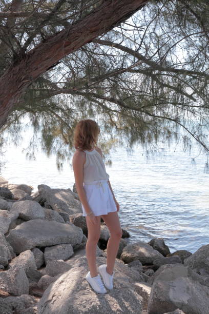 istock Fir tree on a sea side. Woman. 659152318