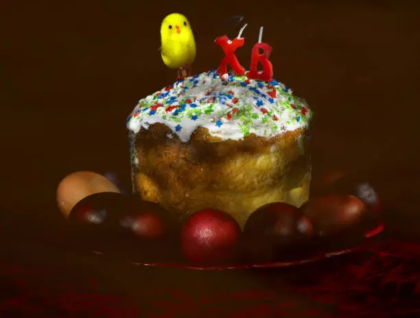 Easter cake and eggs on dark background, morning after easter. Paintd with lightbrush