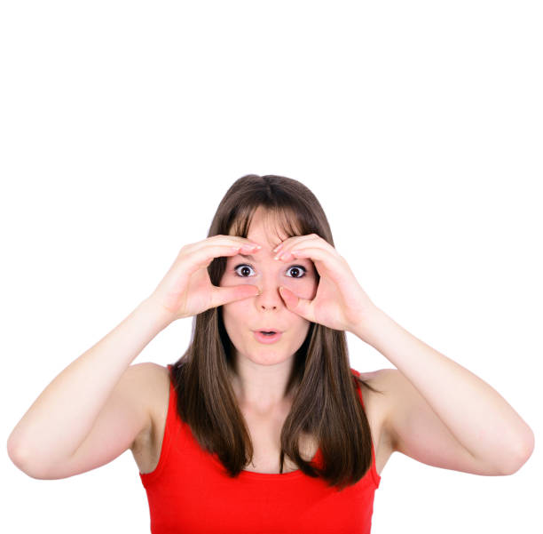 istock Portrait of young woman looking through imaginary binoculars isolated on white 659172862
