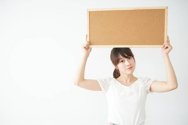 istock Young woman holding board with smile 659191018