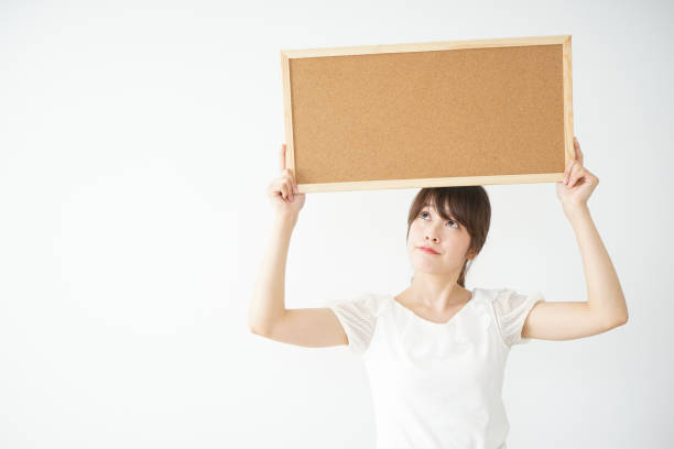 istock Young woman holding board with smile 659191074
