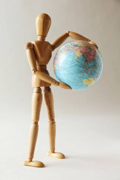 istock The wooden figure holds Earth.Isolated on white 659192234