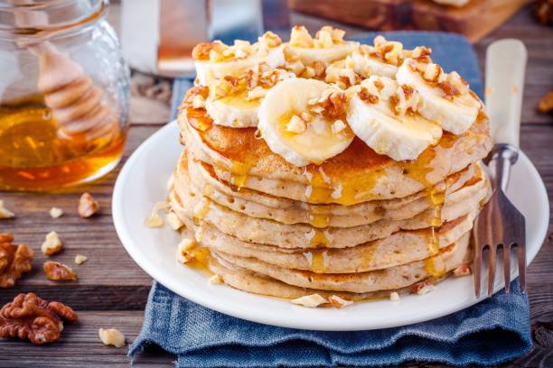 istock Oat pancakes with banana, walnuts and honey 659192794