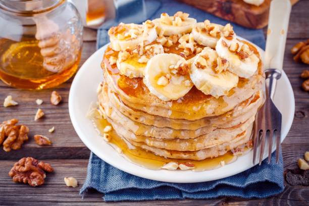 istock Oat pancakes with banana, walnuts and honey 659193226