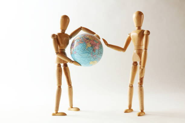 istock The wooden figure holds Earth.Isolated on white 659210358