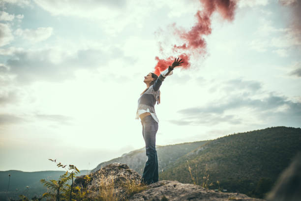 istock Young woman holding flaming torch 659211564