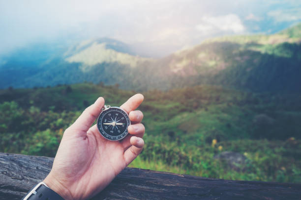 istock Traveler woman holding a compass on 659212518