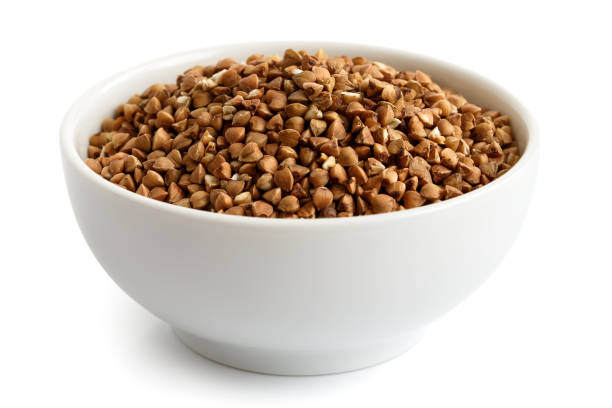 istock Dry buckwheat in white ceramic bowl isolated on white. 659212952