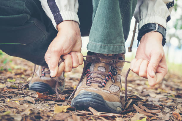 istock Traveler man Hands Lacing up Trekking Shoes 659213552