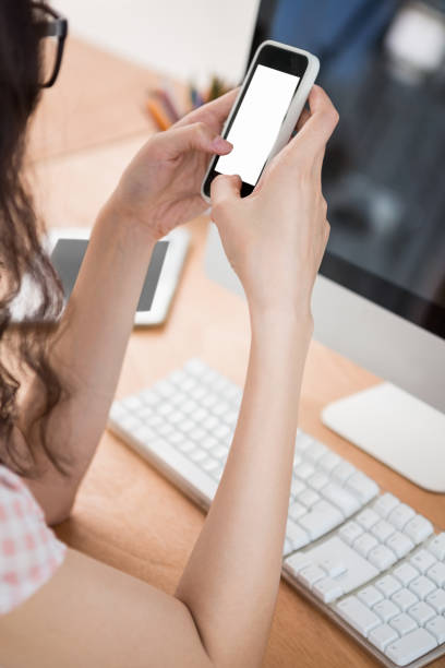 istock A business woman is using her phone 659221694
