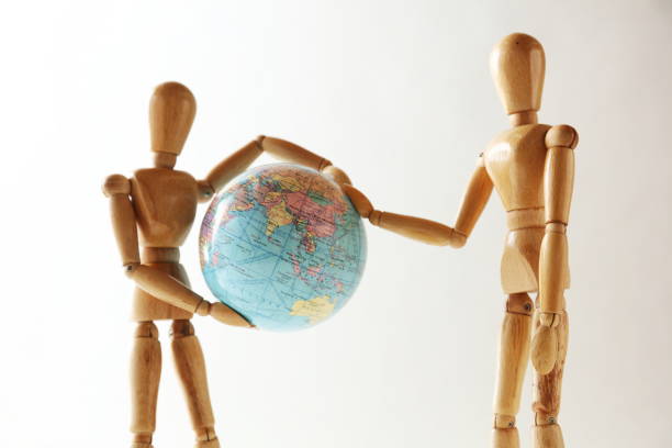 istock The wooden figure holds Earth.Isolated on white 659222354