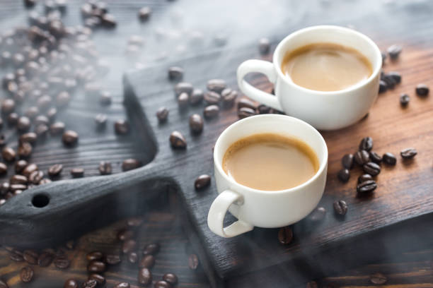 istock Two cups of coffee with coffee beans 659229246