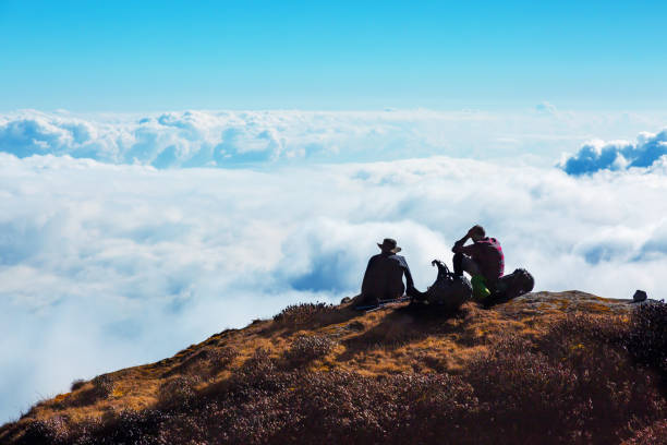 istock People relaxing on Mountain Cliff enjoying cloud Sky Horizon 659232060