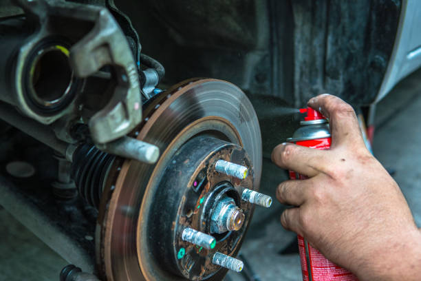 istock Close up mechanic repairing disk break with spraying oil 659232908