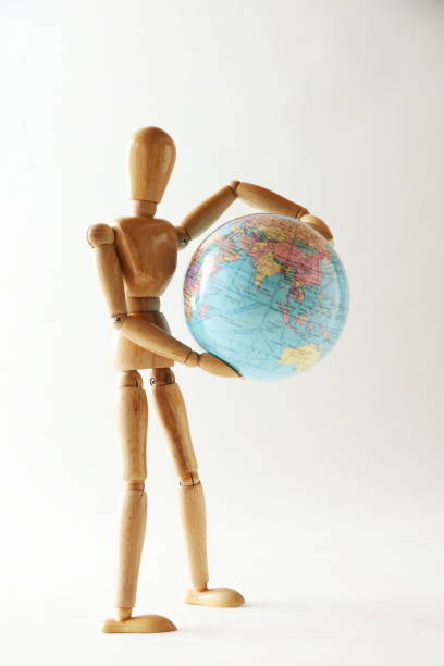 istock The wooden figure holds Earth.Isolated on white 659242924