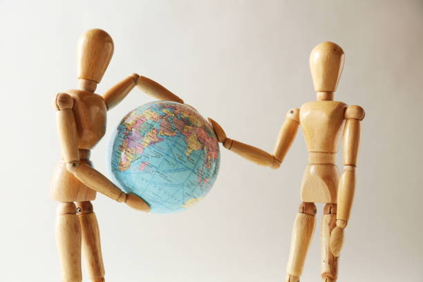 istock The wooden figure holds Earth.Isolated on white 659243816
