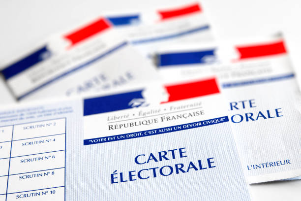 French electoral voter cards official government allowing to vote paper close-up placed on white bright table Close-up of French electoral card, mainly white color with blue, white and red colors from french flag symbol. This is a piece of official government paper allowing to vote for all elections, and listing all ballot dates stamp on verso, issued by Interior Ministry for citizens from France over the age of 18 years old registered on the electoral rolls. This photo was taken without any people in beginning of the year 2017. Taken with multiple legal documents placed on bright white color table. With blank ballot stamp date fields. presidential election stock pictures, royalty-free photos & images