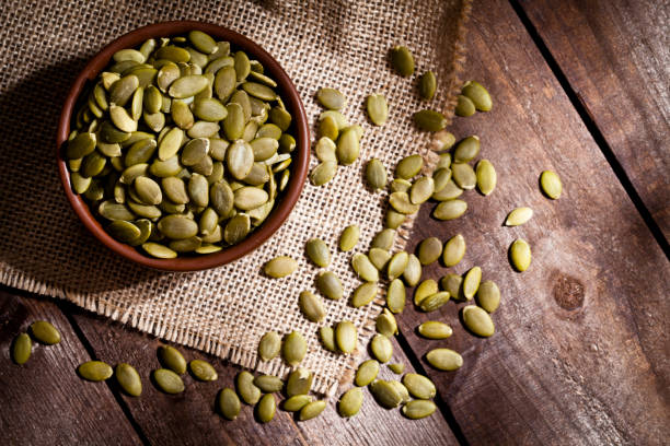 Organic pumpkin seeds still life stock photo