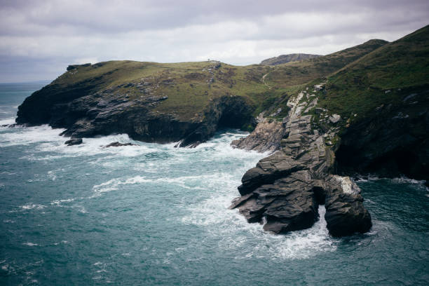 Beautiful rock formations covered by vegetation in Tintagel, England.
