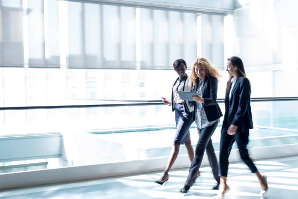 istock Business women walking in a hall 659285520