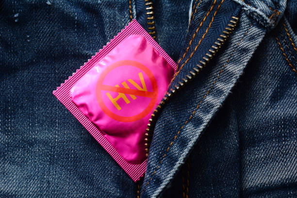 préservatif sur jeans fermeture éclair - concept vih stop - sex condom jeans horizontal photos et images de collection