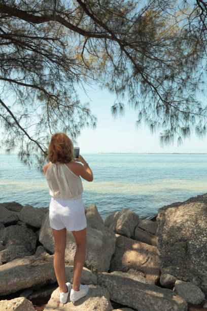 istock Woman on a sea side. Photographing. 659303666